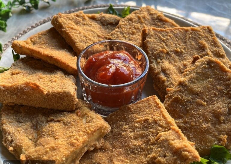 Golden fried cutlets served with a bowl of dipping sauce